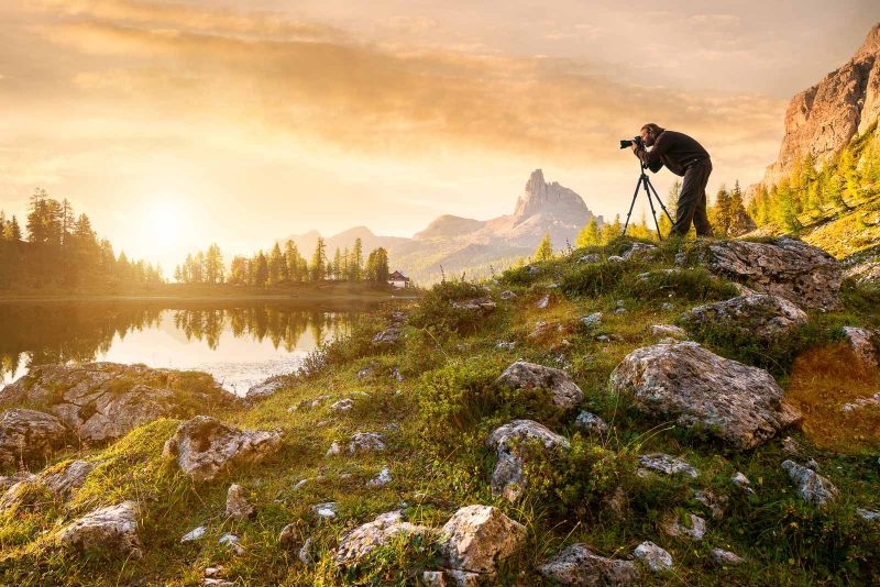 person taking a picture of scenery 