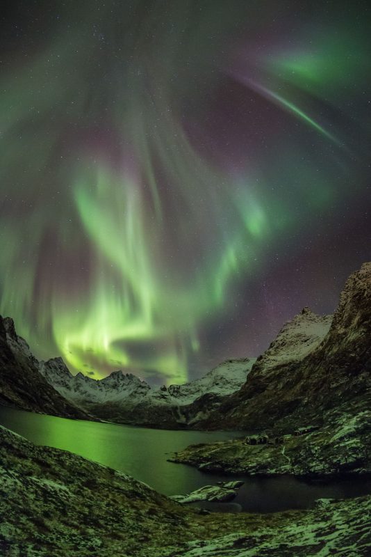 Active Northern Lights above the mountains in the Lofoten Islands